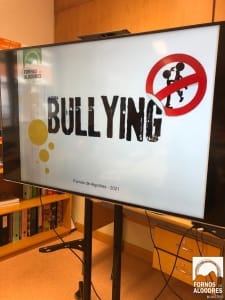 Ecrã exibindo cartaz de campanha contra bullying com símbolo proibitivo e silhueta de criança, logotipo Fornos de Algodres 2021